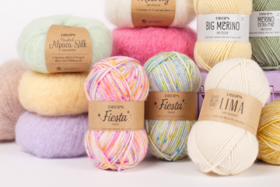 Assorted DROPS yarns in different colors and textures for knitting and crochet projects